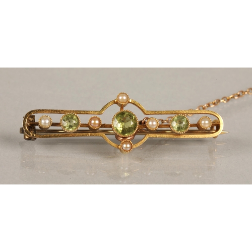 55 - Edwardian yellow metal brooch set with seed pearls and three peridot stones, 3.3g