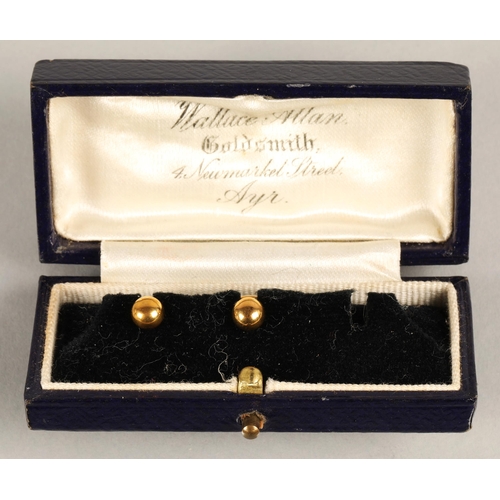 79 - Two 9ct gold button studs, 0.97g