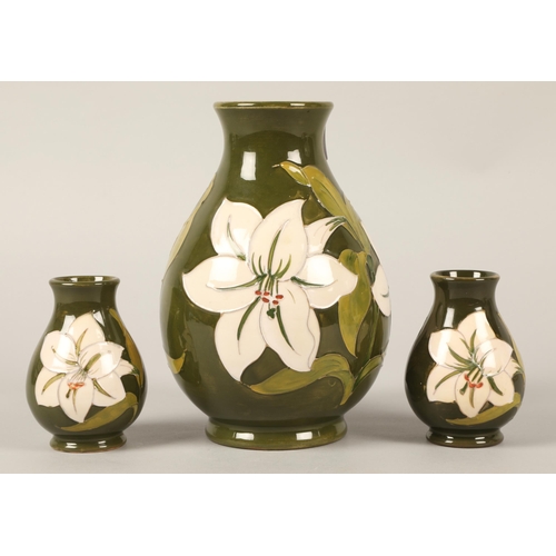 33 - Moorcroft vase, green and white lily design, 20cm h with matching pair small green and white lily de... 