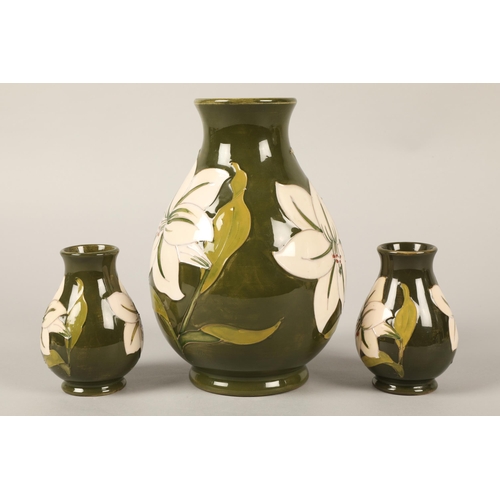 33 - Moorcroft vase, green and white lily design, 20cm h with matching pair small green and white lily de... 