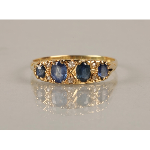 120 - 18ct gold ring set with four blue gems interspersed with diamond chips, ring size U