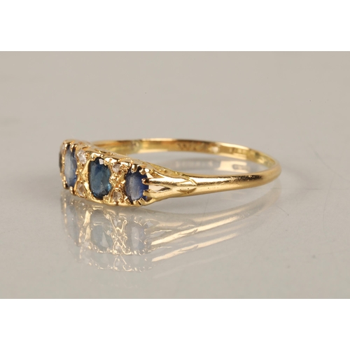 120 - 18ct gold ring set with four blue gems interspersed with diamond chips, ring size U