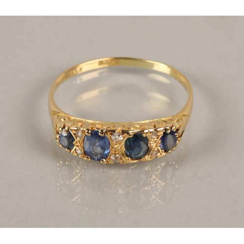 120 - 18ct gold ring set with four blue gems interspersed with diamond chips, ring size U