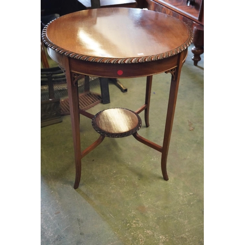 567 - Circular mahogany occasional table with shaped edge.