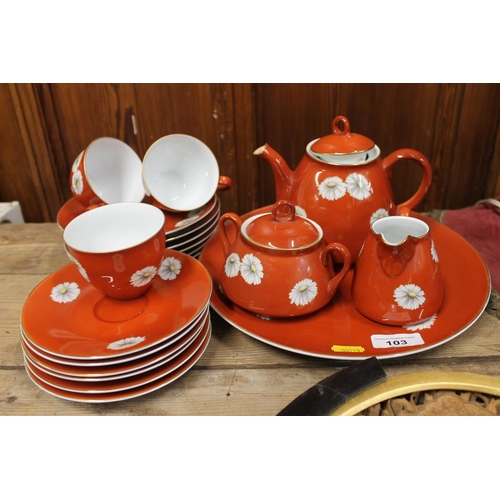 103 - Noritake china tea set, the red brown ground decorated with flowers.