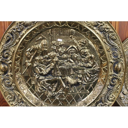 11 - Large brass charger relief decorated with tavern scene and another decorated with a Galleon, max W72... 