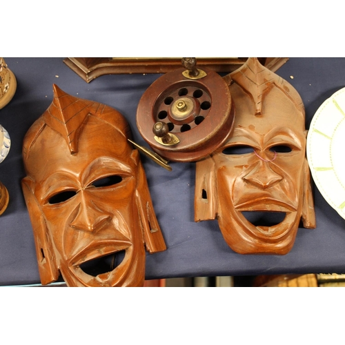 47 - Hamilton and Inches mantel clock, pair of African carved wall masks and a fishing reel.