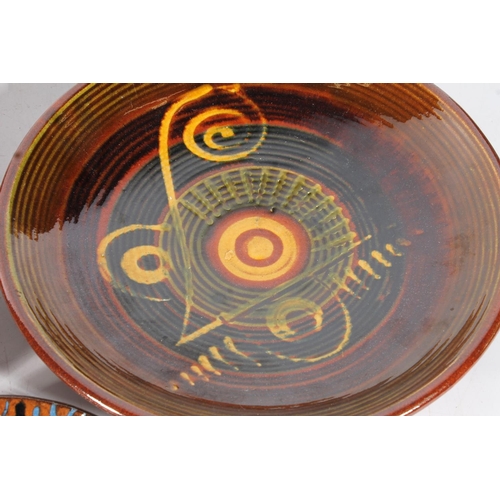 79 - Five Studio Pottery slip glazed Puigdemont wall plates, largest 35cm diameter.