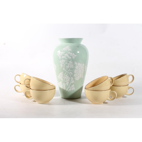 90 - Denby green glazed stoneware vase, 26cm high, and eight Denby Juice Lemon breakfast cups.