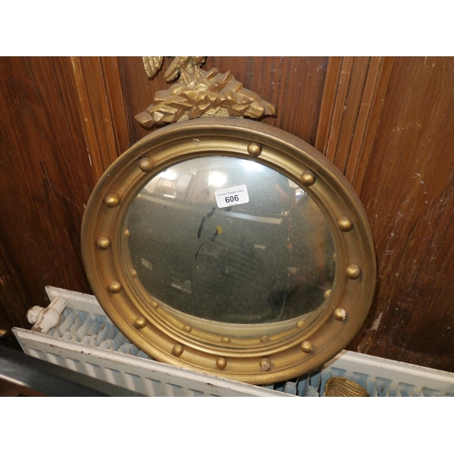 606 - Round gilt frame mirror with eagle crest, W38cm.