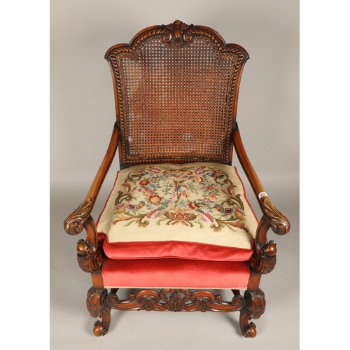 603 - Heavily carved bergere back upholstered open armchair