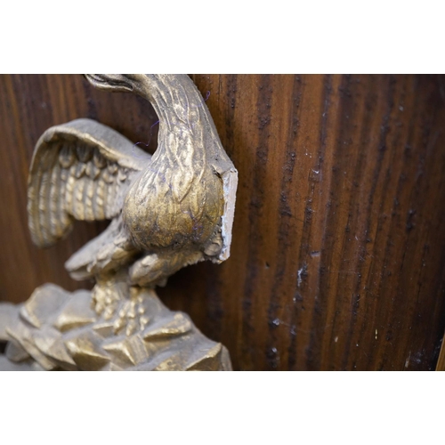 606 - Round gilt frame mirror with eagle crest, W38cm.