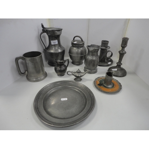 102 - Group of antique pewter to include tappit hen, jug, candlesticks, plate, tankard and a cruisie lamp ... 