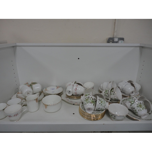 107 - Colclough and other part tea sets, part fruit set, ashets, tureen, plates etc (three shelves).