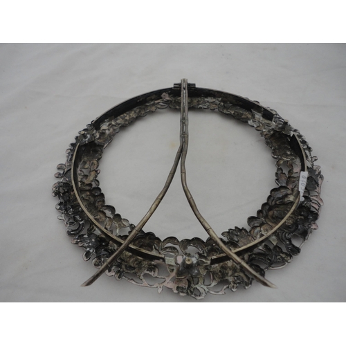 187 - White metal embossed circular photograph frame on an easel support stand.