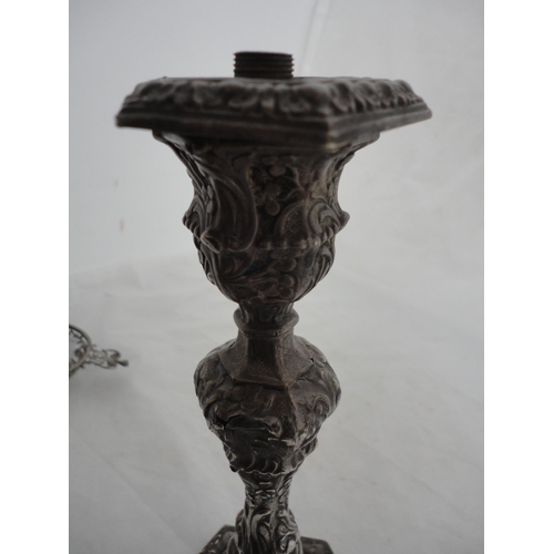 192 - Converted antique silver embossed candlestick with loaded base.