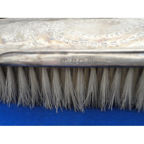 202 - Silver-backed four-piece dressing table set in fitted box.