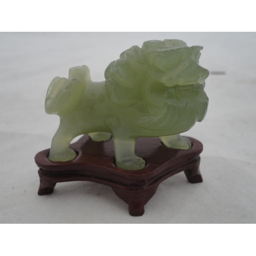 204 - Small Chinese-style jade-coloured censer and cover on stand, and a similar jade-coloured temple dog.... 