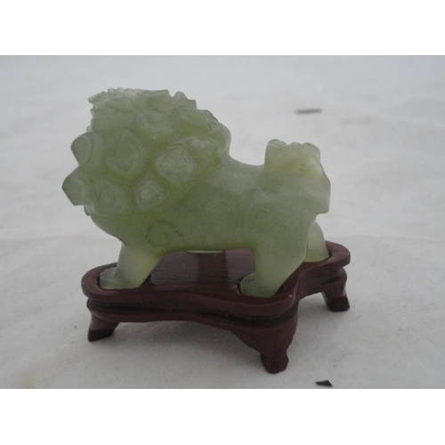 204 - Small Chinese-style jade-coloured censer and cover on stand, and a similar jade-coloured temple dog.... 