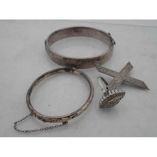 210 - Silver bangle and a child's silver bangle, 30g gross, also a marquis-shaped cocktail ring on silver ... 