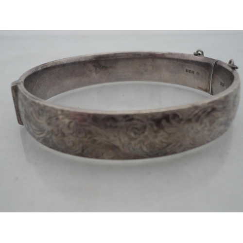 210 - Silver bangle and a child's silver bangle, 30g gross, also a marquis-shaped cocktail ring on silver ... 