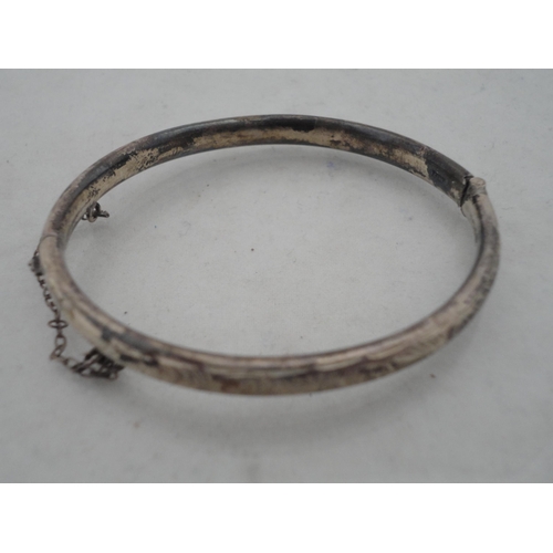 210 - Silver bangle and a child's silver bangle, 30g gross, also a marquis-shaped cocktail ring on silver ... 