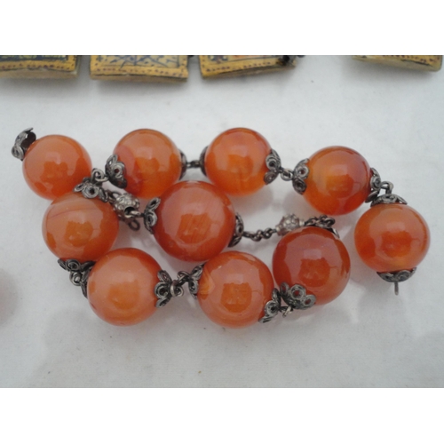 214 - Bag containing assorted decorative jewellery to include a cross pendant, Oriental-themed tiled brace... 