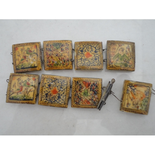 214 - Bag containing assorted decorative jewellery to include a cross pendant, Oriental-themed tiled brace... 