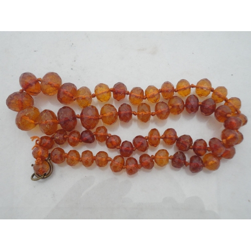 214 - Bag containing assorted decorative jewellery to include a cross pendant, Oriental-themed tiled brace... 