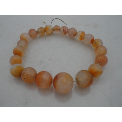 214 - Bag containing assorted decorative jewellery to include a cross pendant, Oriental-themed tiled brace... 