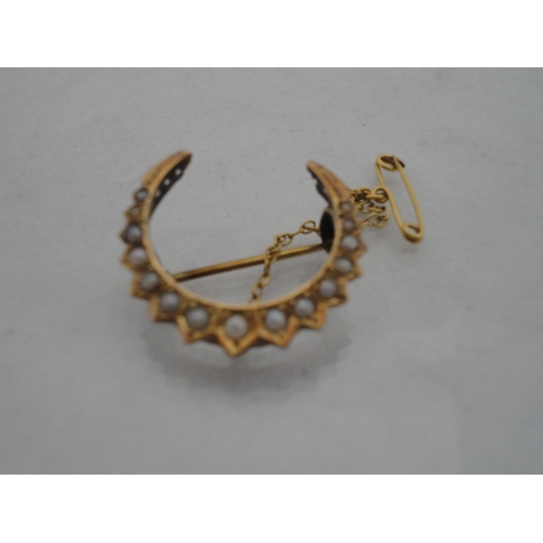221 - 15ct gold and seed pearl-mounted crescent brooch, 3g gross.