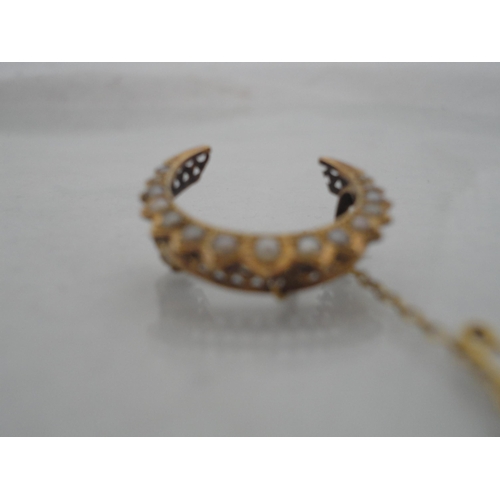 221 - 15ct gold and seed pearl-mounted crescent brooch, 3g gross.