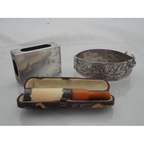 222 - Silver engine-turned vesta holder, 39g, white metal bangle and a cased silver-mounted cheroot holder... 