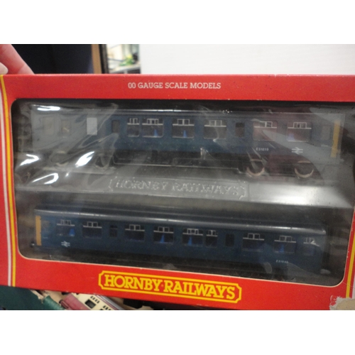 26 - Carton containing 00 gauge coaches and rolling stock to include a boxed Hornby R.267 two car DMU cla... 