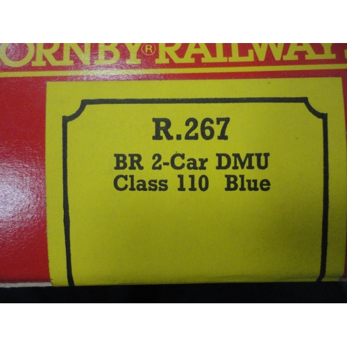 26 - Carton containing 00 gauge coaches and rolling stock to include a boxed Hornby R.267 two car DMU cla... 