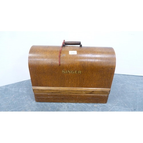 276 - Singer portable sewing machine in an oak case.