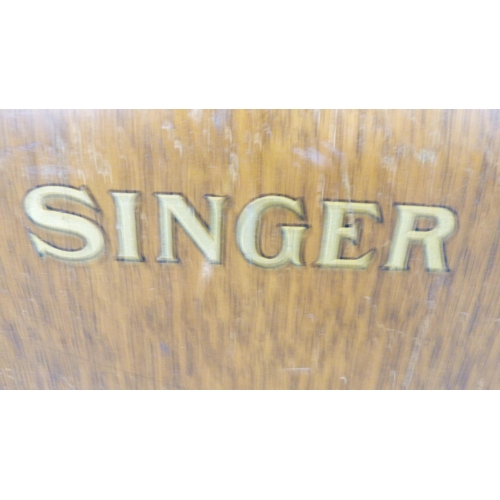 276 - Singer portable sewing machine in an oak case.