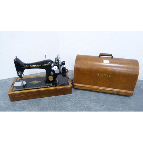 276 - Singer portable sewing machine in an oak case.