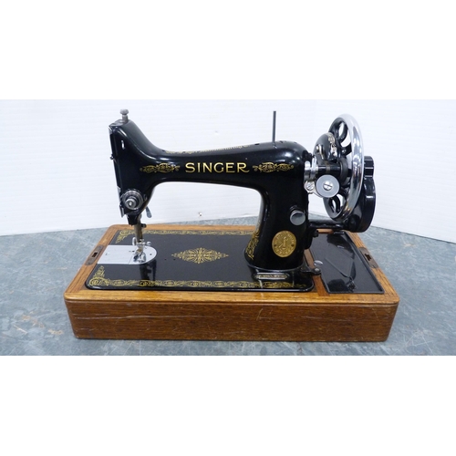 276 - Singer portable sewing machine in an oak case.