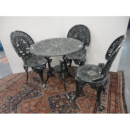 290 - Reproduction Coalbrookdale-style garden table, painted in green, three similar chairs and a parasol ... 