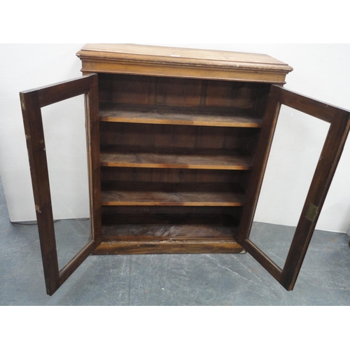 307 - 19th century two-door bookcase with glazed doors enclosing shelves.