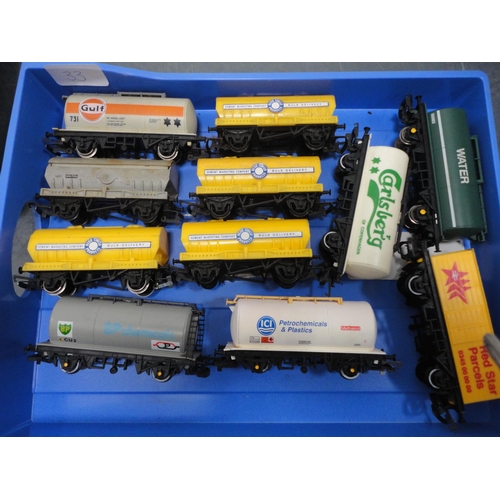 33 - Four small cartons containing 00 gauge rolling stock, tankers, accessories etc.