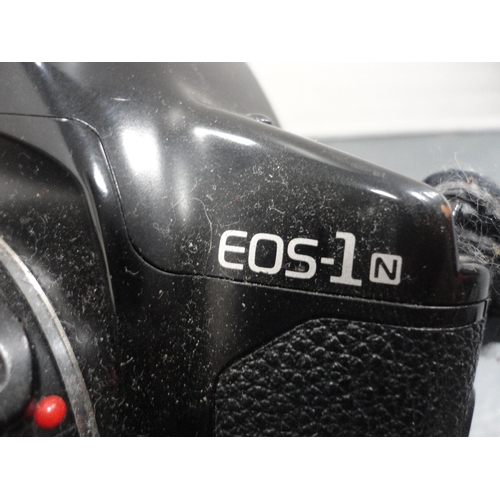 60 - Canon EOS-1 camera, with Canon lens attached, a Canon  ET-83 70-200mm lens, a box camera and accesso... 