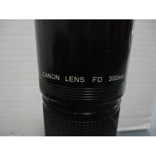 60 - Canon EOS-1 camera, with Canon lens attached, a Canon  ET-83 70-200mm lens, a box camera and accesso... 