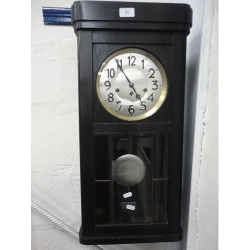 65 - Stained oak wall clock.