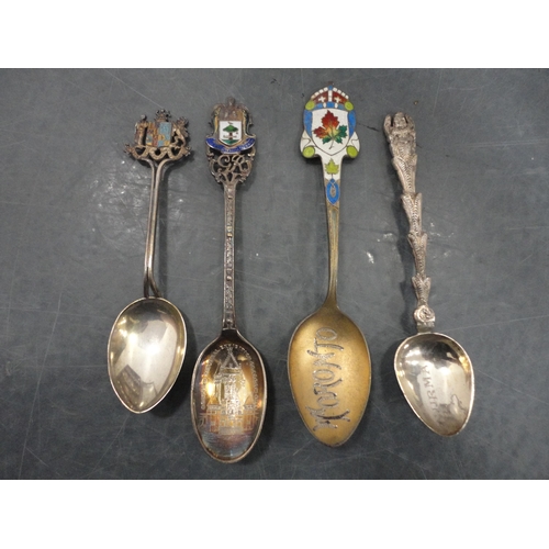 68 - Collection of souvenir spoons to include some silver examples, contained in a display case.