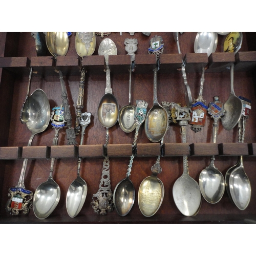 68 - Collection of souvenir spoons to include some silver examples, contained in a display case.