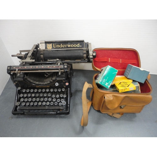 74 - Underwood typewriter and a box containing camera accessories.