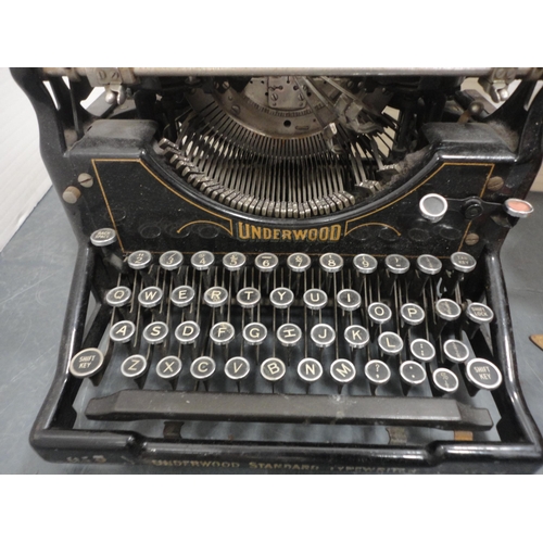 74 - Underwood typewriter and a box containing camera accessories.