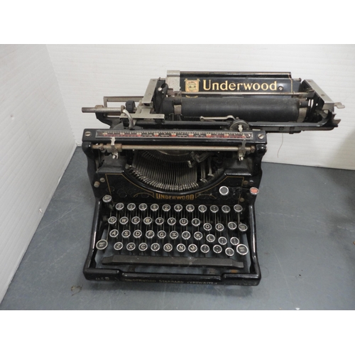 74 - Underwood typewriter and a box containing camera accessories.